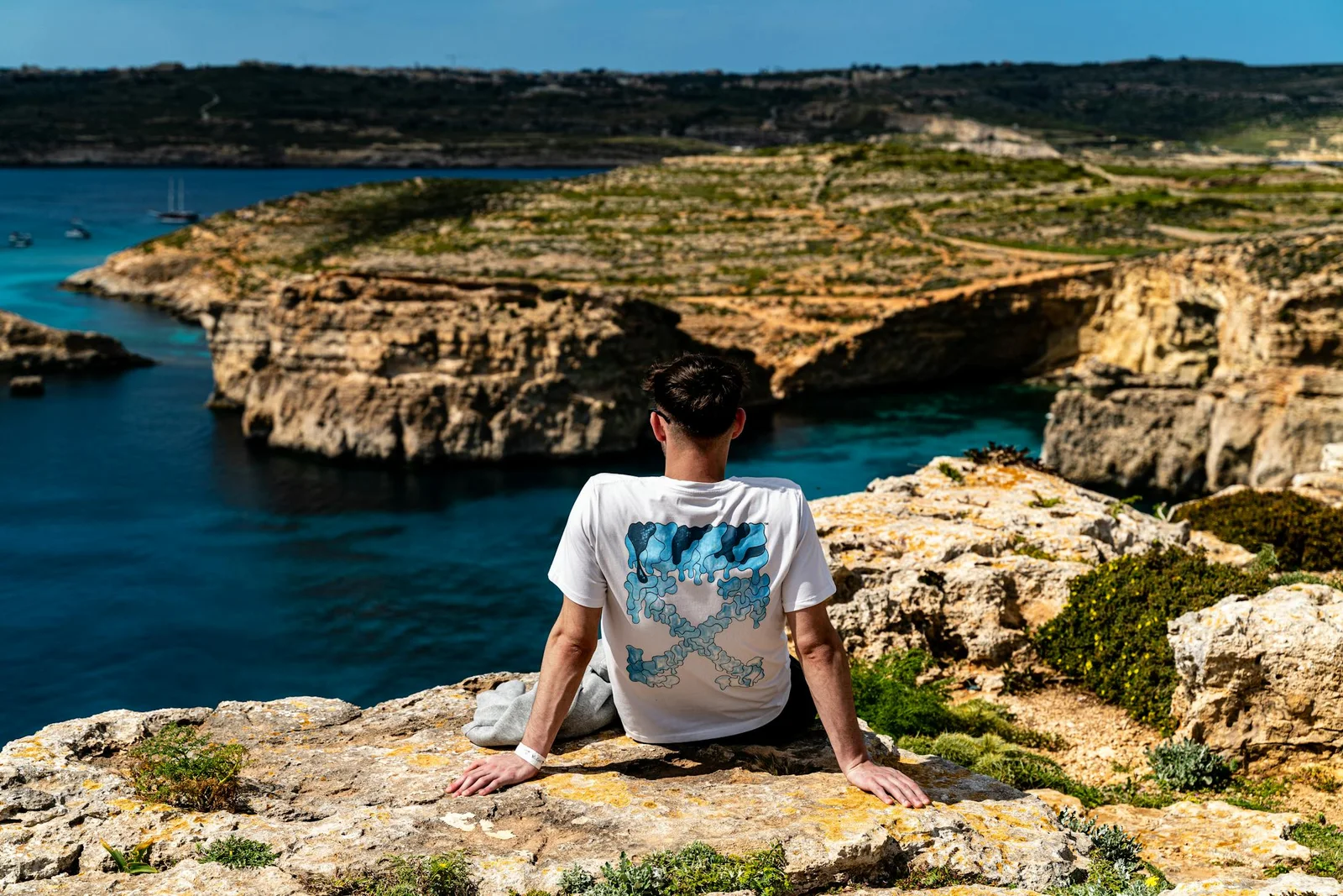 Sunny Gozo cliffs above clear blue water